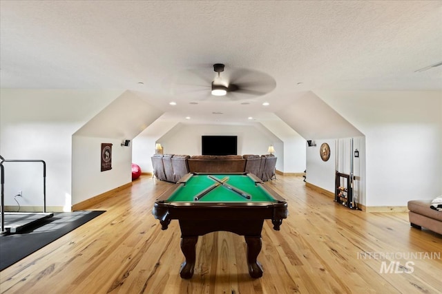 playroom with light wood-style floors, baseboards, vaulted ceiling, and a ceiling fan