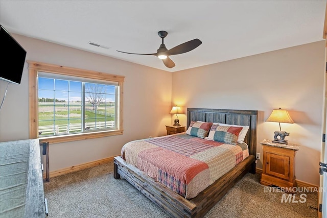 bedroom featuring carpet floors, a ceiling fan, baseboards, and visible vents