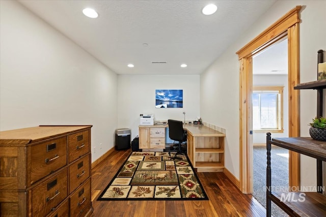 home office featuring recessed lighting, baseboards, and dark wood-type flooring