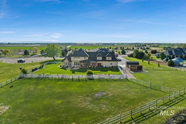 birds eye view of property with a rural view