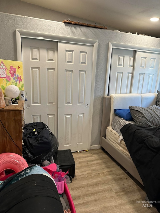 bedroom with a closet and light hardwood / wood-style floors