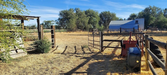 view of yard with a rural view and an outdoor structure