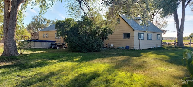 rear view of property with a lawn