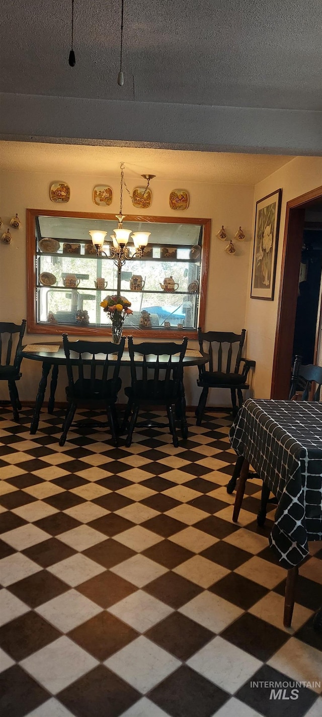 dining room featuring a textured ceiling