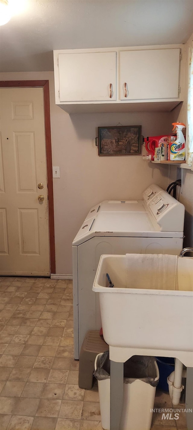 washroom featuring cabinets, separate washer and dryer, and sink