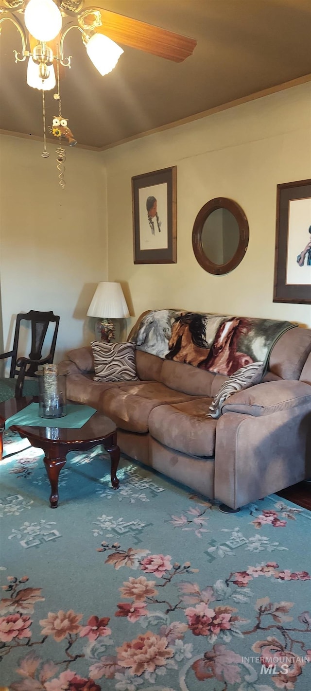 living room with ceiling fan and crown molding