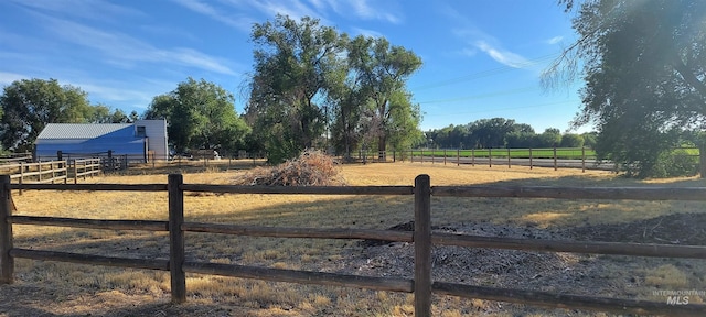 view of yard with a rural view