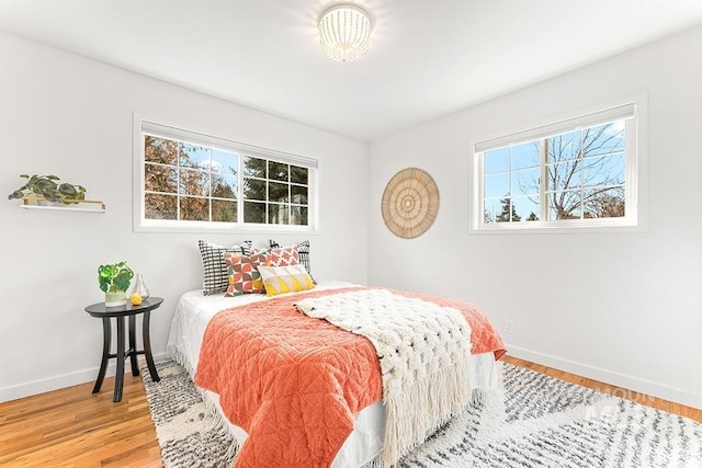 bedroom featuring wood finished floors and baseboards