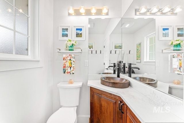 bathroom featuring toilet and vanity