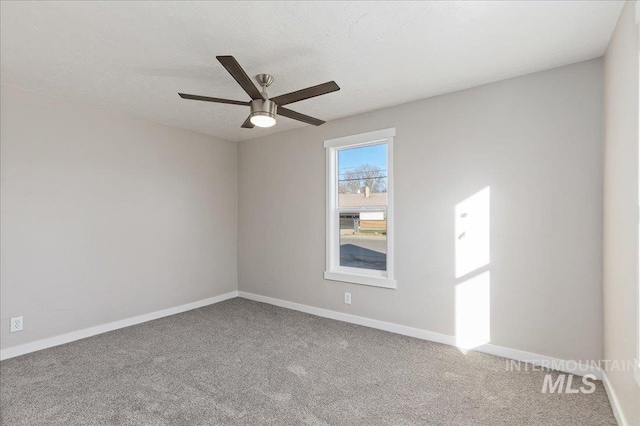 carpeted spare room with a textured ceiling and ceiling fan