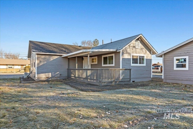 view of front facade with a front lawn and a wooden deck