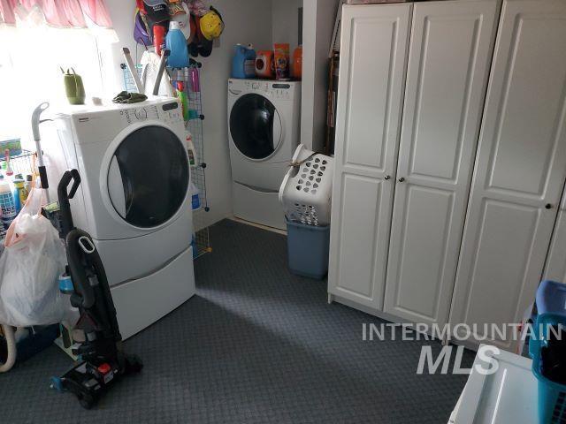 3460 American River Rd, Elk City, ID 83525 - laundry room featuring washing machine and clothes dryer, carpet, and cabinet space