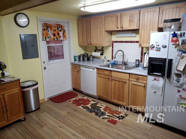 3460 American River Rd, Elk City, ID 83525 - kitchen featuring electric panel, a sink, light countertops, light wood-style floors, and white appliances
