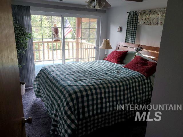 3460 American River Rd, Elk City, ID 83525 - bedroom featuring carpet flooring, access to outside, ceiling fan, and multiple windows