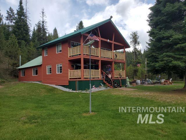 3460 American River Rd, Elk City, ID 83525 - back of property featuring faux log siding, stairway, a yard, and a deck