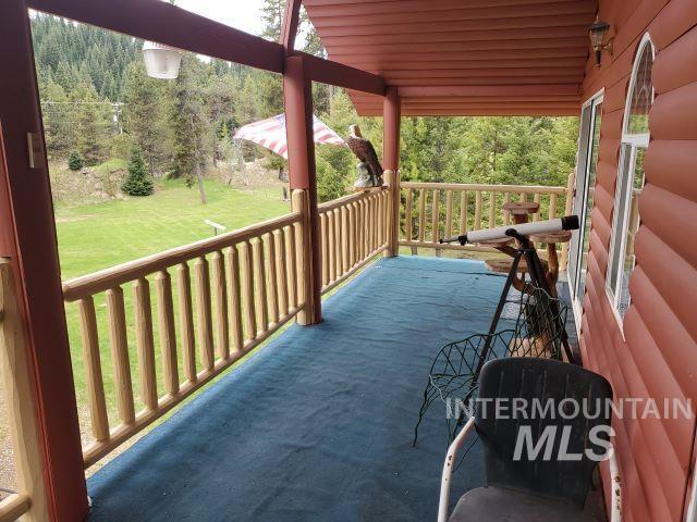 3460 American River Rd, Elk City, ID 83525 - wooden terrace with a view of trees and a yard