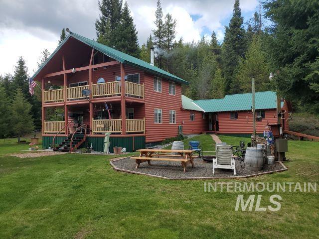 3460 American River Rd, Elk City, ID 83525 - back of house with a lawn, faux log siding, and a deck