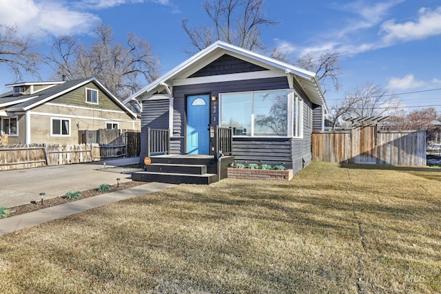 bungalow-style home with a front yard