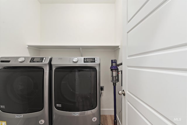 6009 W Riva Capri St, Meridian, ID 83646 - washroom with baseboards, wood finished floors, washer and clothes dryer, and laundry area