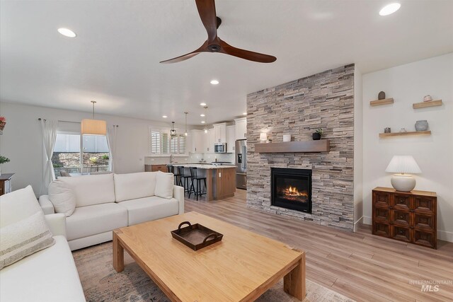 6009 W Riva Capri St, Meridian, ID 83646 - living area featuring ceiling fan, recessed lighting, a fireplace, and light wood-type flooring