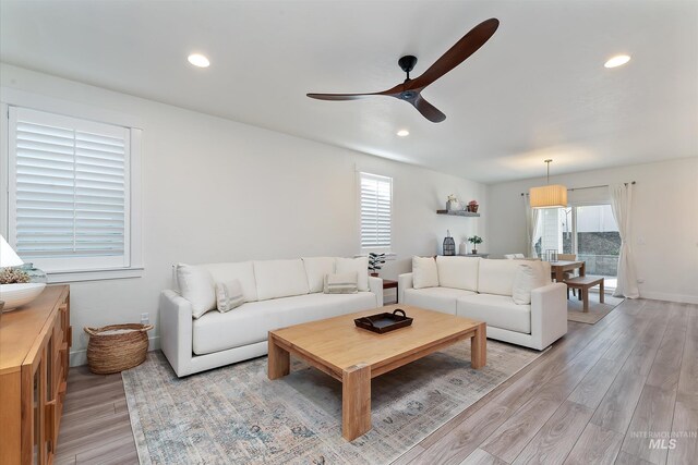 6009 W Riva Capri St, Meridian, ID 83646 - living room featuring ceiling fan, baseboards, light wood-style floors, and recessed lighting
