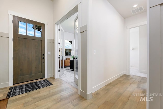 entrance foyer with light wood-type flooring and a wealth of natural light