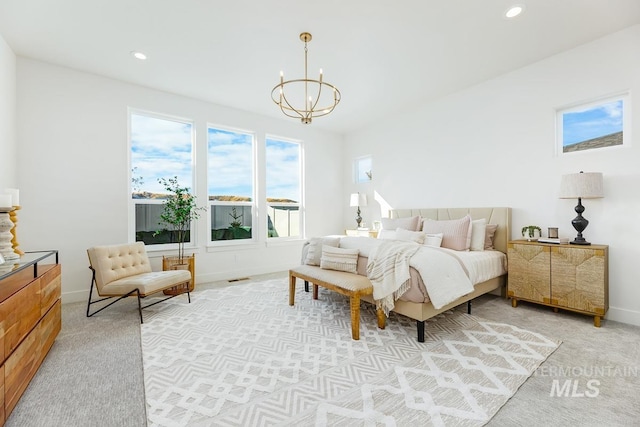 carpeted bedroom featuring a chandelier