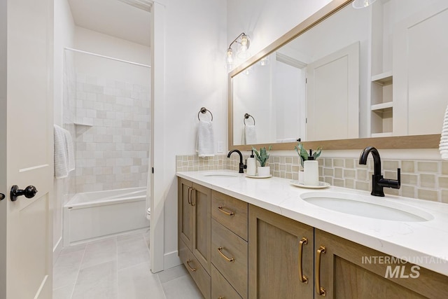 bathroom with vanity, tile patterned flooring, tiled shower / bath, and tasteful backsplash