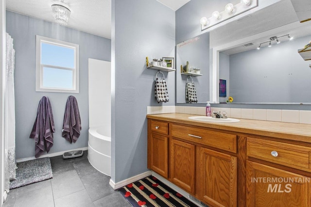 16042 N Saint Helens Dr, Nampa, ID 83651 - full bath with a bath, baseboards, tile patterned flooring, a shower, and vanity