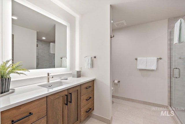 bathroom with vanity, a shower with shower door, and toilet