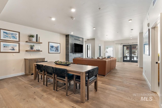 dining room featuring french doors and light hardwood / wood-style floors