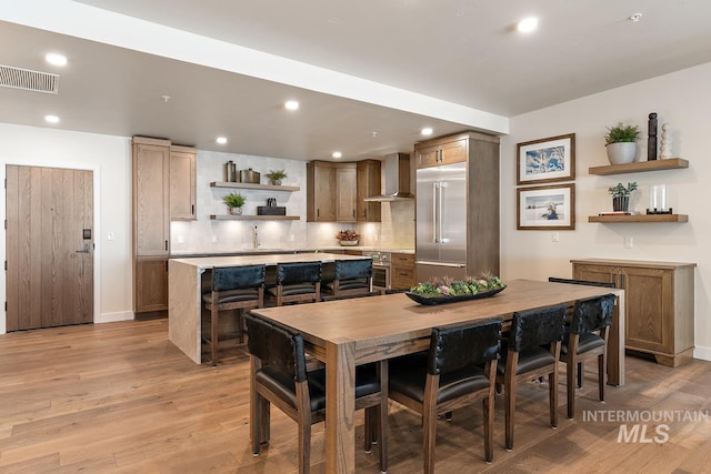 dining area featuring light wood-type flooring