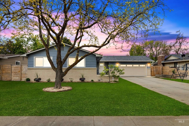 view of front of property with a garage, brick siding, fence, a front lawn, and concrete driveway