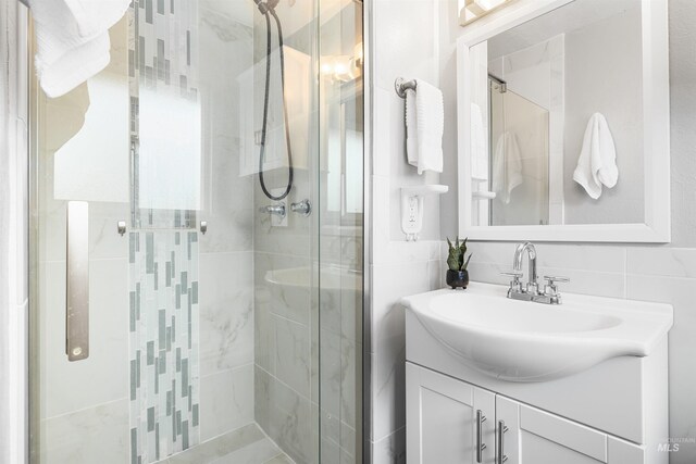full bathroom with vanity and a shower stall