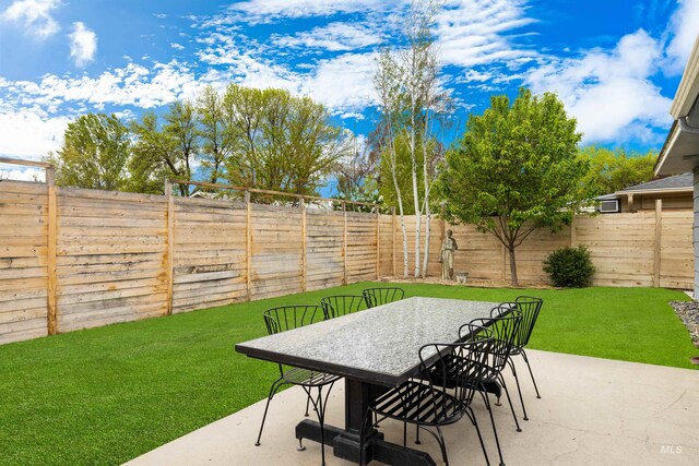 view of patio featuring a fenced backyard and outdoor dining space