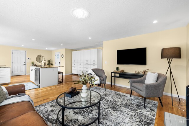 living area with baseboards and light wood-style flooring