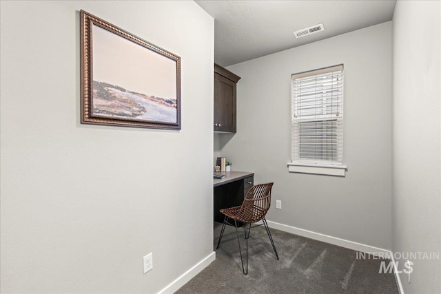 office area featuring dark colored carpet