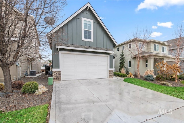 view of front of home with central AC and a garage