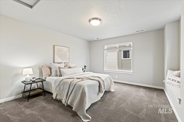 bedroom featuring dark colored carpet