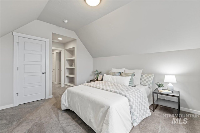 carpeted bedroom featuring vaulted ceiling