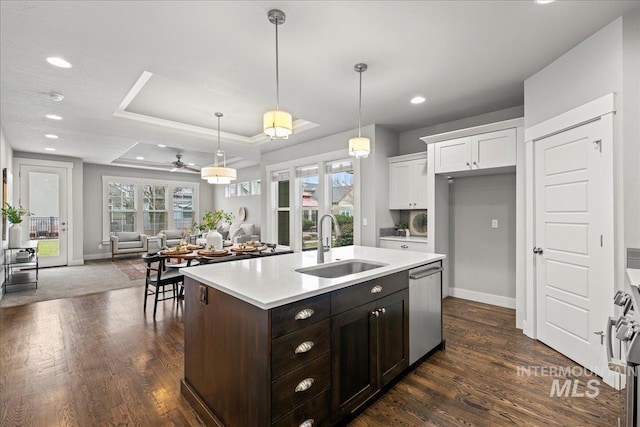 kitchen with dishwasher, sink, hanging light fixtures, ceiling fan, and white cabinetry