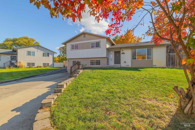 tri-level home with a front lawn