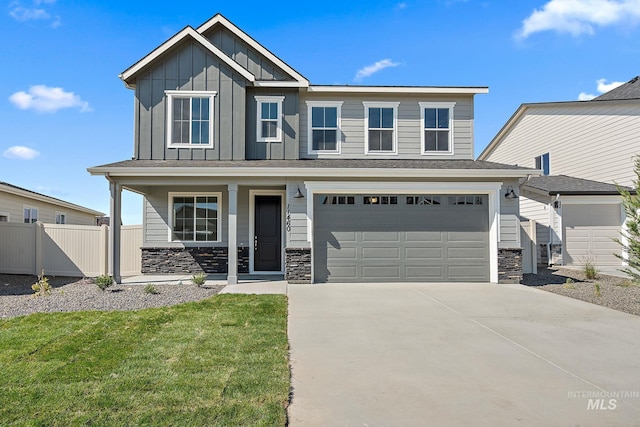 craftsman-style house with stone siding, fence, covered porch, board and batten siding, and concrete driveway