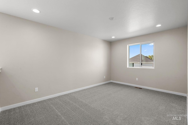 spare room with recessed lighting, visible vents, baseboards, and carpet flooring