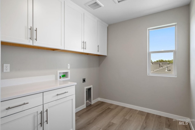 washroom with visible vents, baseboards, hookup for a washing machine, cabinet space, and electric dryer hookup