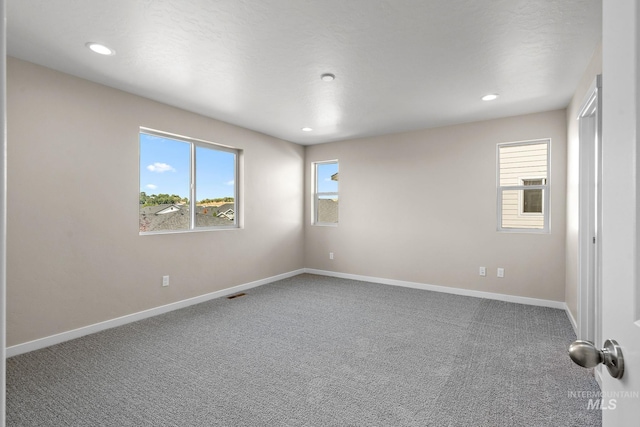 carpeted empty room with recessed lighting and baseboards