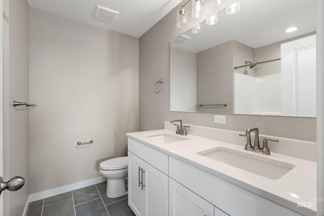 bathroom featuring tile patterned flooring, toilet, visible vents, and a sink