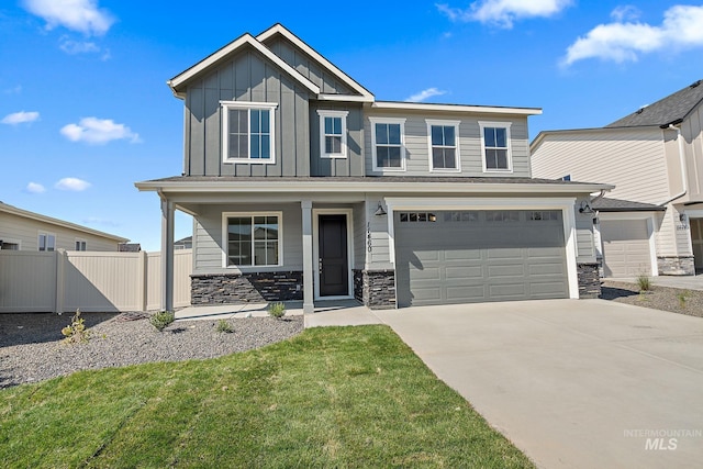 craftsman-style home with a porch, fence, board and batten siding, and stone siding