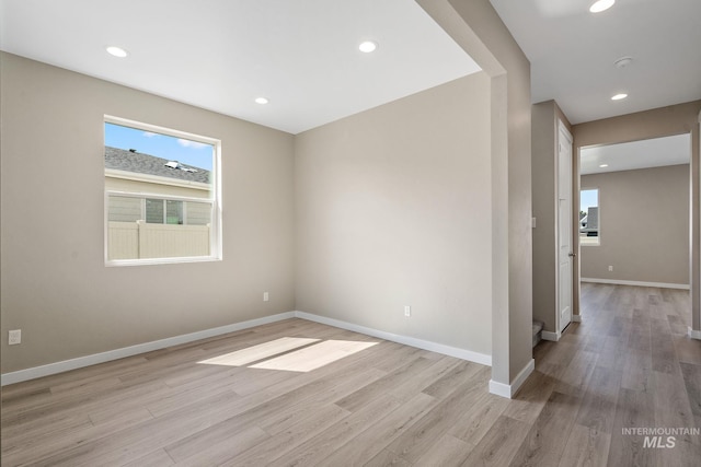 unfurnished room with recessed lighting, light wood-type flooring, and baseboards