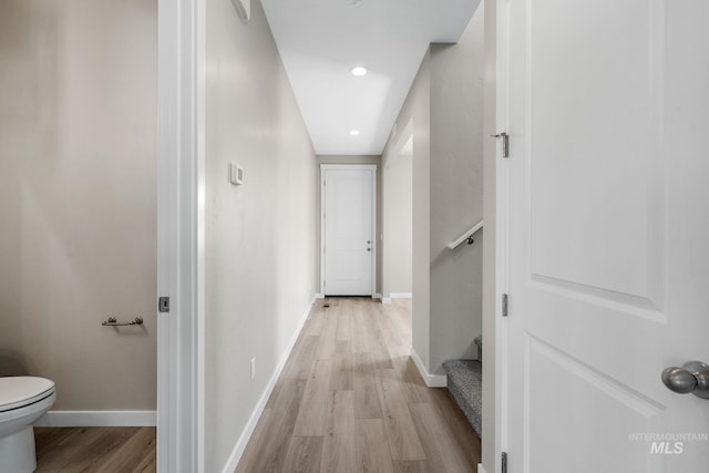 hall featuring stairway, recessed lighting, light wood-type flooring, and baseboards